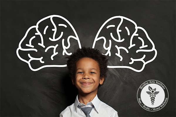 Mindfulness is at the core of Healing Arts Programs - Smiling child in front of blackboard